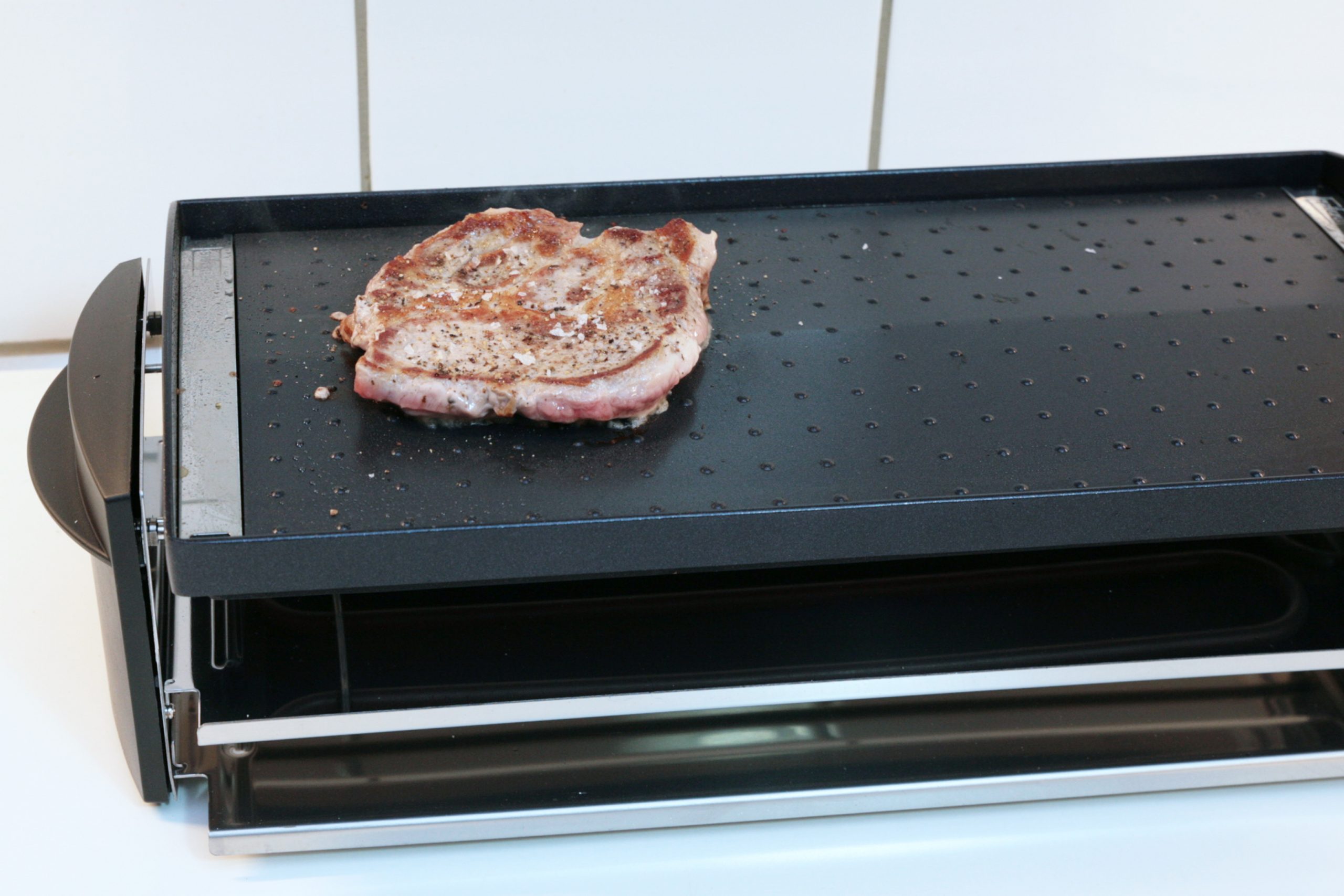 Raclette Grill mit gebratenem Fleisch