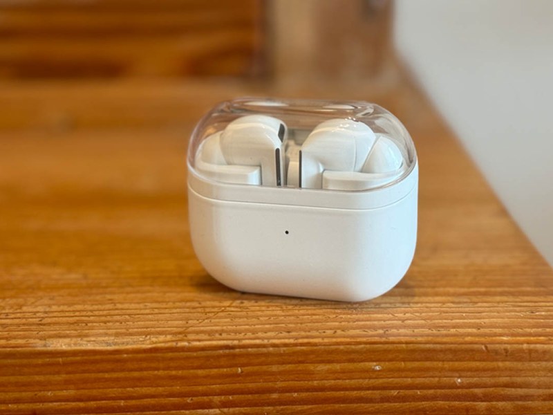 Galaxy Buds 3 Pro in weißem Case auf einem Holztisch