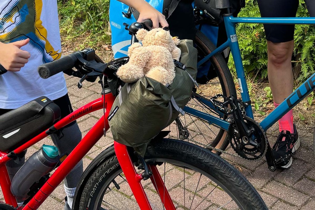 Nahaufnahme Zelt-Tasche an einem Lenker, darauf ein Stoffteddy